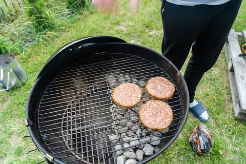 Selective focus of fresh delicious burger cutlets grilling on bbq grill Stock Photos