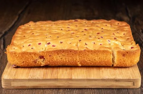 Selective focus on the front of a berry pie cut into pieces on a cutting boar Stock Photos