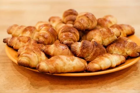 Selective focus on the front small croissant. Small croissants, homemade cakes Stock-Fotos