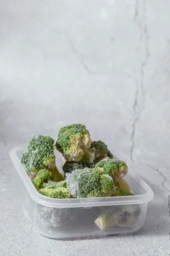 Selective focus. frozen broccoli in a clear container Stock Photos