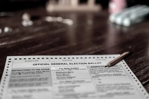 Selective focus on a generic election ballot with a pencil on top. Stock Photos