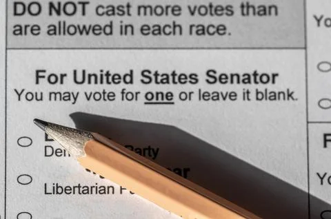 Selective focus on a generic election ballot with a pencil on top. Stock Photos
