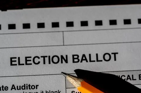 Selective focus on a generic election ballot with a pencil on top. Stock Photos