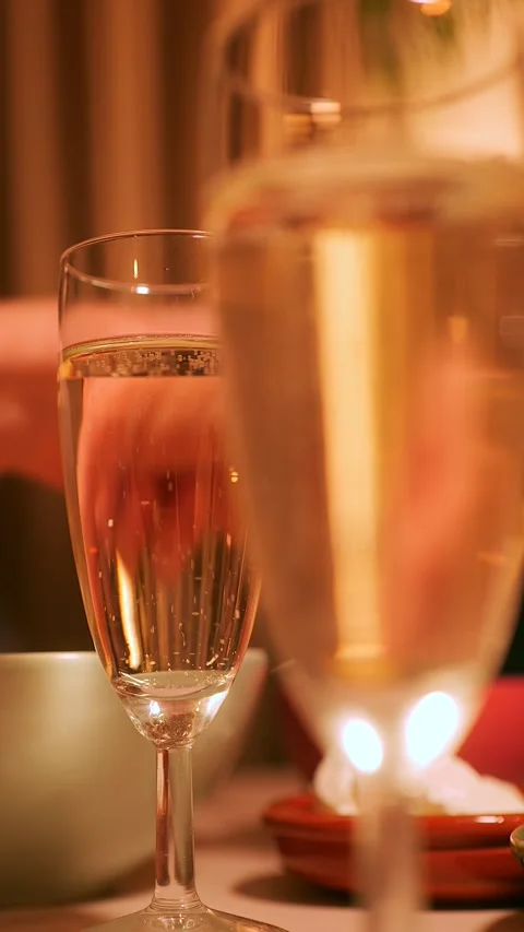 Selective focus on glass of champagne with bubbles on table at dinner party Stock-Footage 295027872