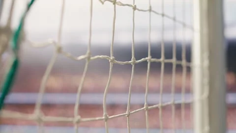 Selective focus goal net and post detail on football pitch under stadium light Stock Footage 338000731