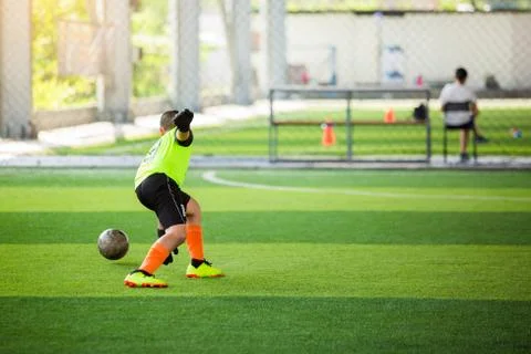 Selective focus to goalkeeper is jumping to catching the soccer ball. Blurry  Stock Photos