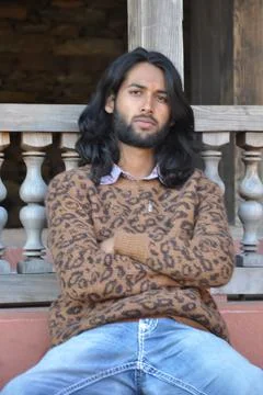 Selective focus of a good looking Indian young man with long hair style Stock Photos