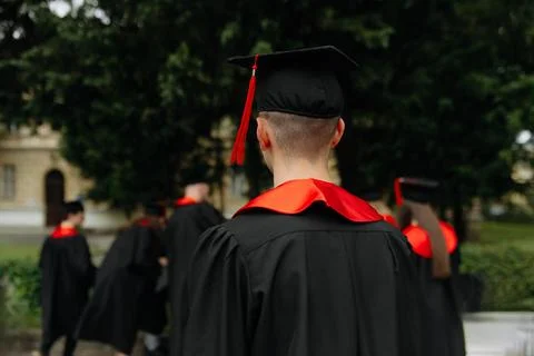 Selective focus on graduation cap of group of students. black uniform of stud Stock Photos