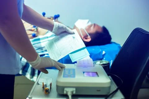 Selective focus to graph from Electrocardiogram with blurry nurse measuring p Stock Photos