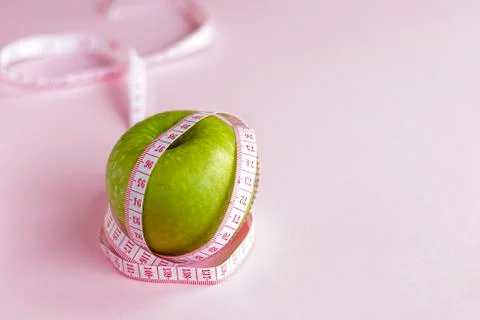 Selective focus, green Apple with measuring tape wrapped Stock Photos