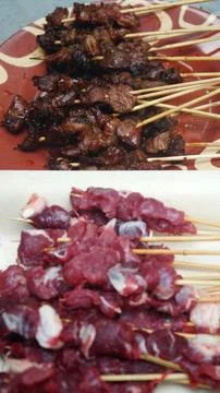 Selective Focus of Grilled Beef Satay with Raw Skewers Foreground Stock Photos