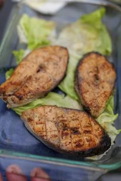 Selective focus. Grilled fish, grilled salmon steak with spices and vegetables Stock Photos
