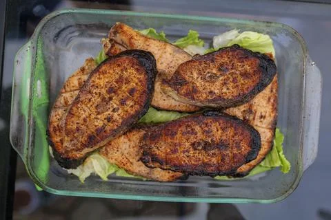 Selective focus. Grilled fish, grilled salmon steak with spices and vegetables Stock Photos