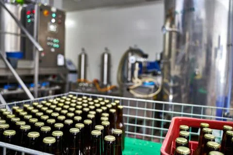 Selective focus on a group of capped beer bottles in a brewery ready to be di Stock Photos