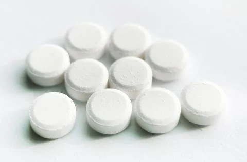 Selective focus, group of white medical pills isolated on white background Stock Photos