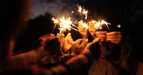 Selective focus, Group of young friends holding fire burning sparklers Stockbeeldmateriaal 221386866