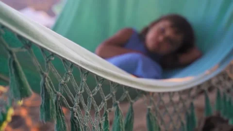 Selective focus in hammock with kid. Happy child relaxing in hammock with focus Stock Footage 168216117
