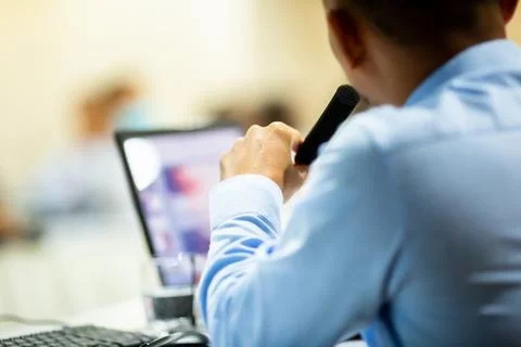 Selective focus to hand and desktop wireless conference microphones with blur Stock Photos