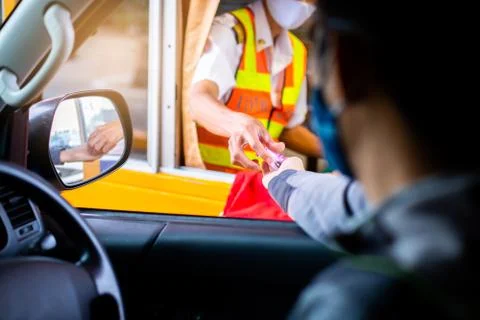 Selective focus to hand of driver pay for the expressway. Blurry image of dri Stock Photos