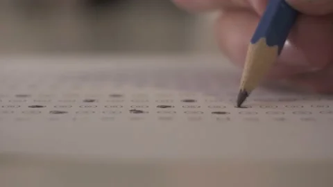Selective Focus Of A Hand Filling Out The Answer Sheet With Standardized Stock Footage 172586942