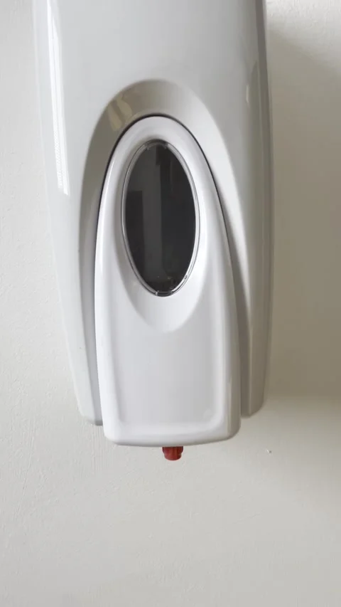 Selective focus on hand hygiene promotion with wall sanitizer in office Stock Footage 313713964