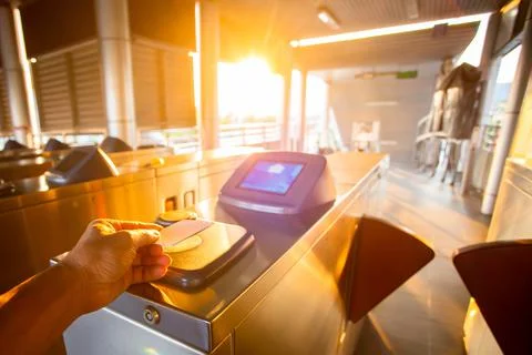 Selective focus to hand of passenger using smart card to open automatic gate  Stock Photos