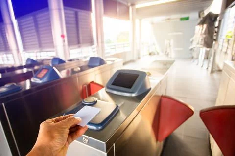 Selective focus to hand of passenger using smart card to open automatic gate  스톡 사진