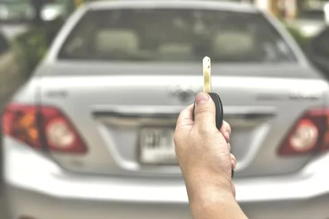 In selective focus of Hand presses on the remote control car alarm systems Stock Photos