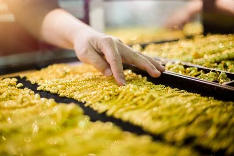Selective focus to hand is selecting gold jewelry. Stock Photos