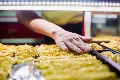 Selective focus to hand is selecting gold jewelry. Stock Photos