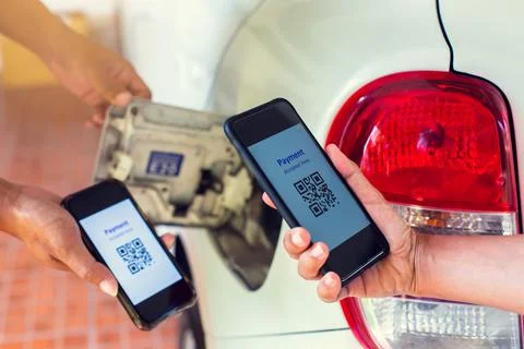 Selective focus to Hand using smart phone to scan QR code tag with blurry fue Stock Photos