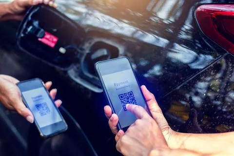 Selective focus to Hand using smart phone to scan QR code tag with blurry fue Stock Photos