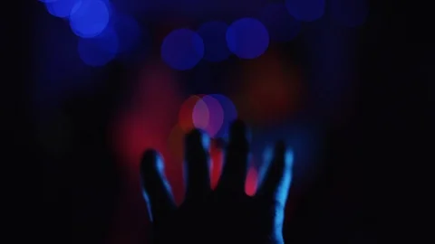 Selective focus on hand waving in neon lights. Male open hand gesture on a dark Stock Footage 111221009