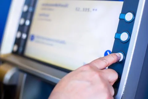 Selective focus to hands choosing option on ATM machine. Customer using ATM a Stockfoto's