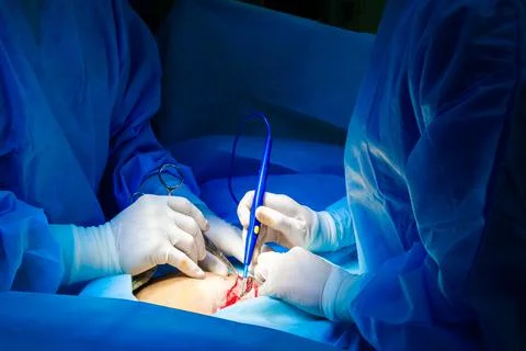 Selective focus on the hands of doctors wearing white sterile gloves. Stock Photos