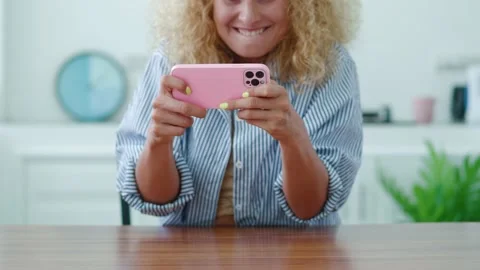 Selective focus on the hands of a red-haired excited youg blonde woman playing Stock Footage 218565857