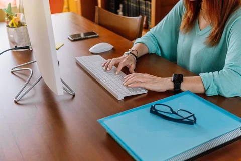 Selective focus on the hands of a woman while teleworking with a computer Stock Photos