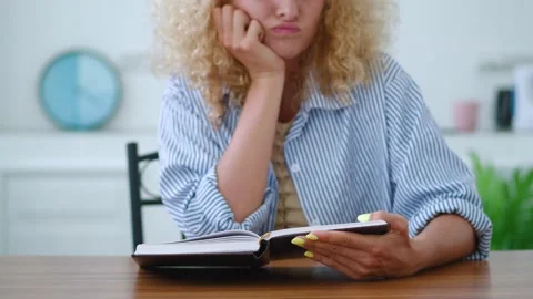 Selective focus on the hands of young curly-haired blonde woman, flipping Stock Footage 218566009
