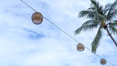 Selective Focus. The Hanging Handmade Wicker Lanterns on the Wire. Stock Photos