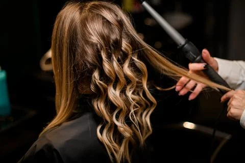 Selective focus on head with beautiful curled strands of hair. Photos
