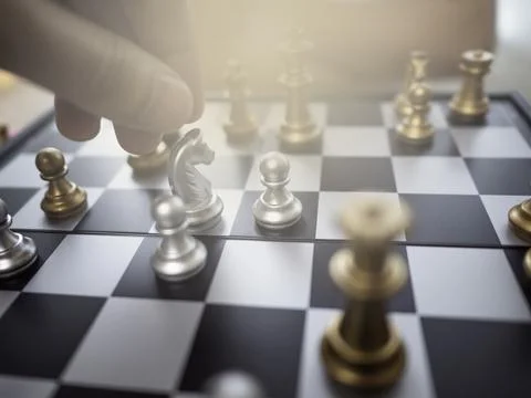 Selective focus on horse chess while man checkmate to the king Stock Photos