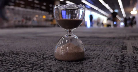 Selective focus on hourglass at terminal, time-lapse of airport rush Stock Footage 326390786