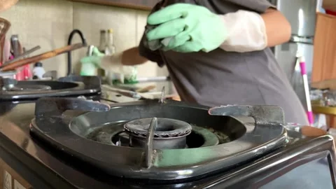 Selective Focus Of Housewives Cleaning Gas Stove In The Kitchen Close Up Stock Footage 343516996