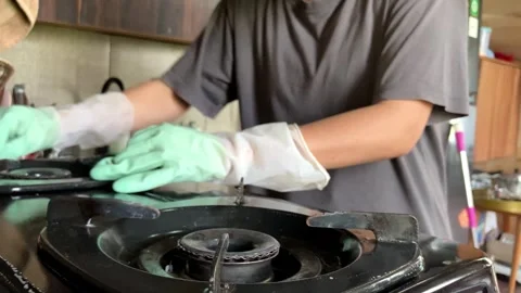 Selective Focus Of Housewives Cleaning Gas Stove In The Kitchen Close Up-2 Vídeo Stock 343517201