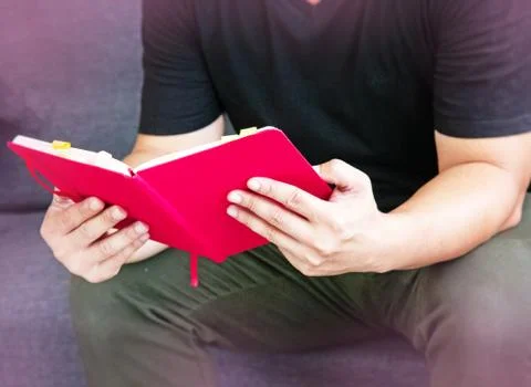In selective focus of Human hands holding book,reading book at lviing room,bl 写真素材