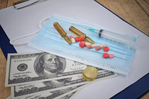 Selective focus image of bank note ,syringe, vial injection and pills tablet  Stock Photos