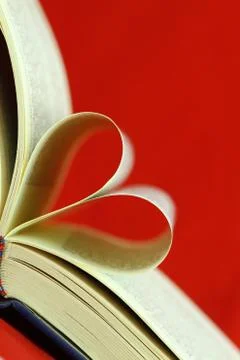 Selective focus image of book pages folded into a heart shape Stock Photos