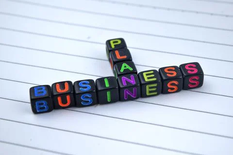 Selective focus image of BUSINESS PLAN wording on a white paper. Business and Stock Photos