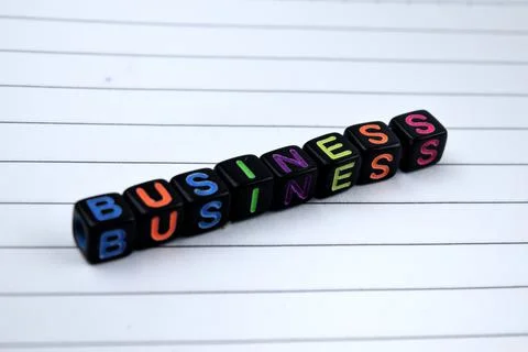 Selective focus image of BUSINESS wording on a white paper. Business and econ Stock Photos