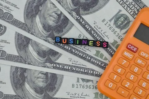 Selective focus image of BUSINESS wording on bank note and calculator. Busine Stock Photos